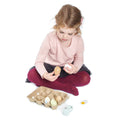 Child playing with Wooden Eggs Toy Food set, holding wooden eggs from a carton, encouraging imaginative kitchen and food role play.